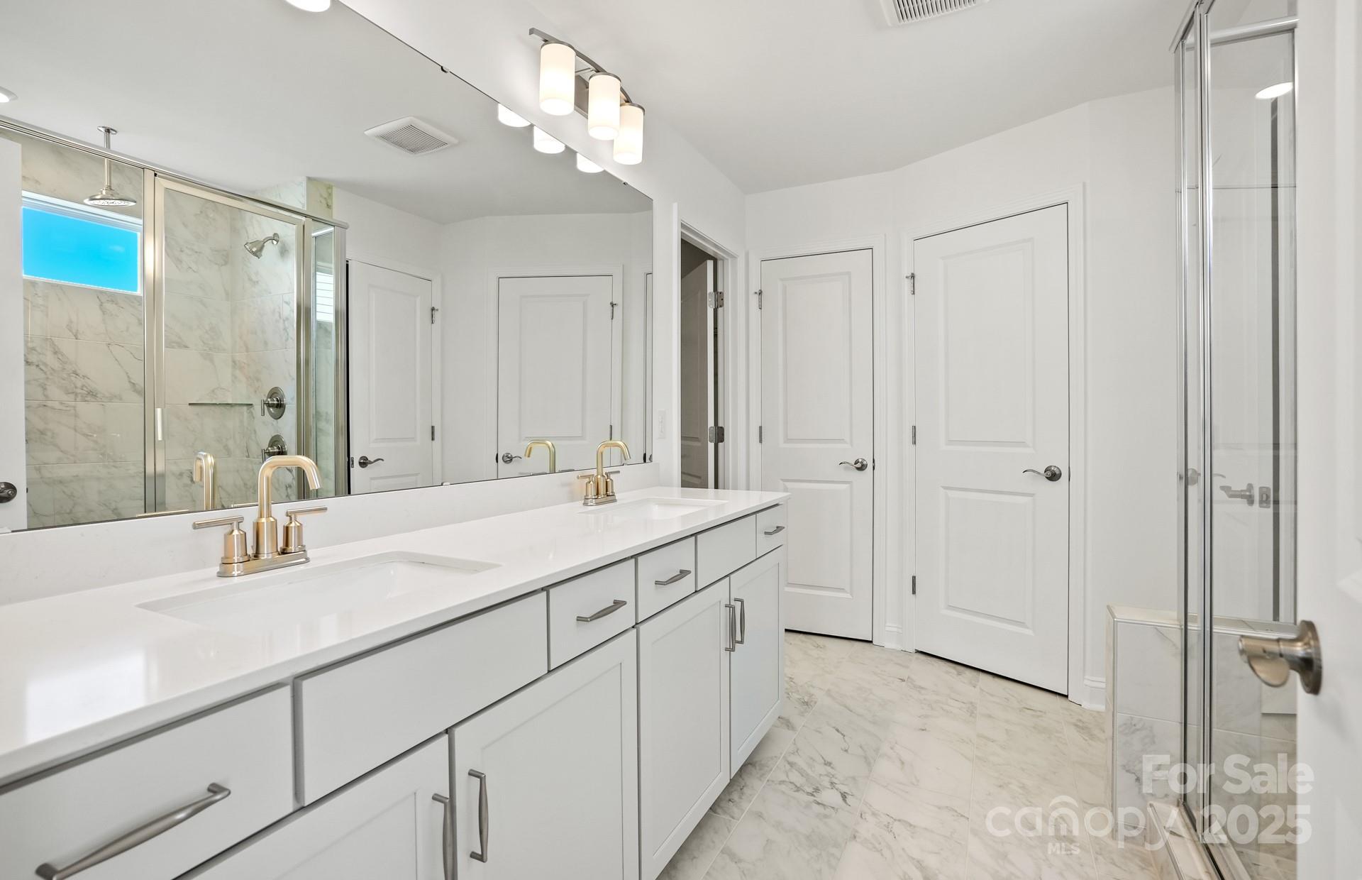 2234 Millenium Drive, Unit 84 Lancaster, SC 29720 - Photo 32 of 37 a bathroom with 2 sink and a mirror