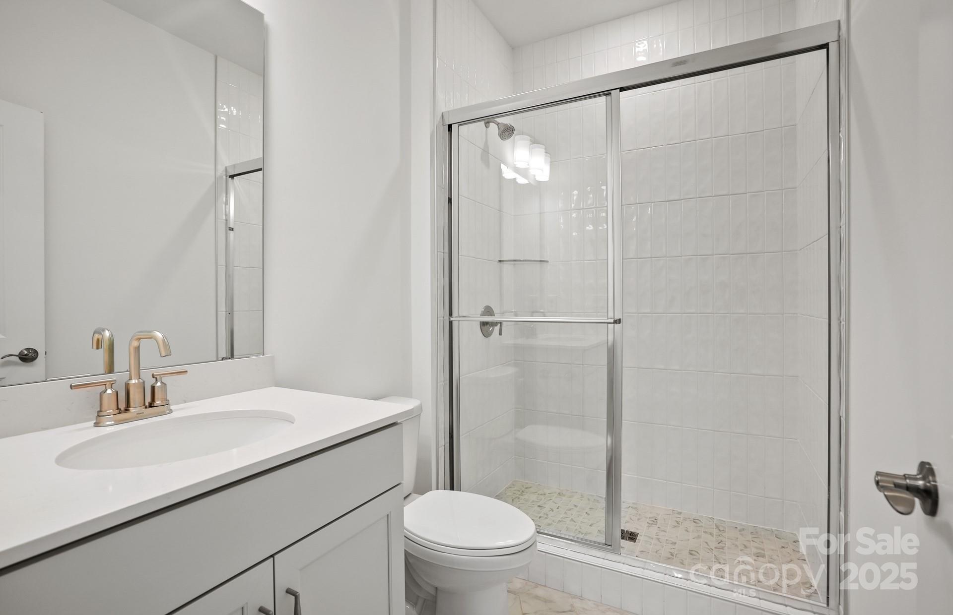 2234 Millenium Drive, Unit 84 Lancaster, SC 29720 - Photo 8 of 37 a bathroom with a sink toilet and shower