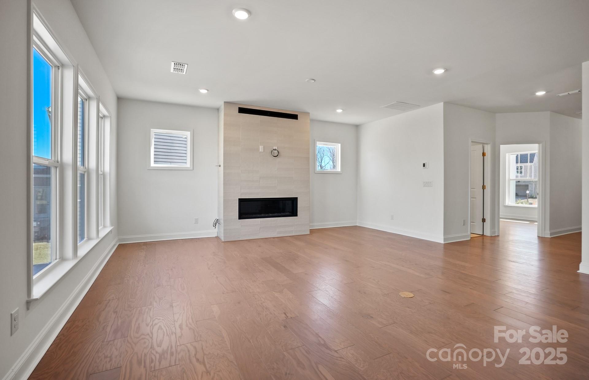 2234 Millenium Drive, Unit 84 Lancaster, SC 29720 - Photo 10 of 37 a view of empty room with wooden floor and fireplace