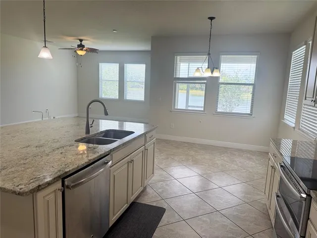 a kitchen with a sink a counter space and a window