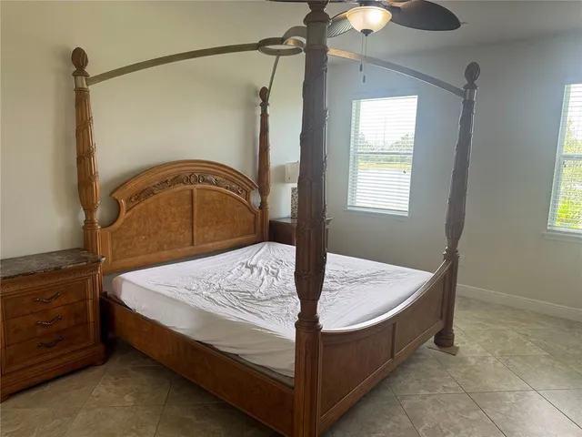 a bed sitting in a bedroom next to a window