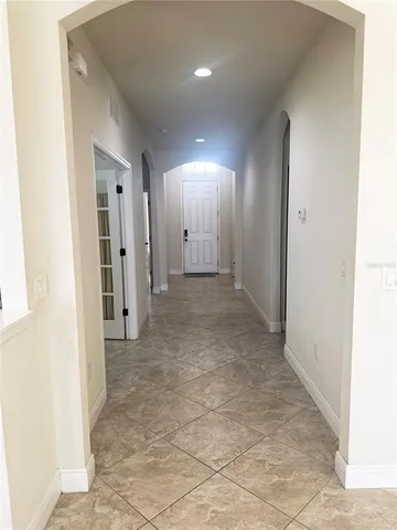 a view of a hallway with wooden shelves