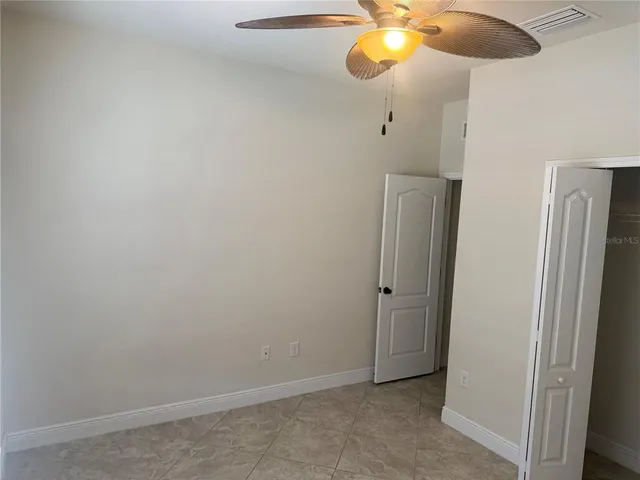 a view of a chandelier fan and closet