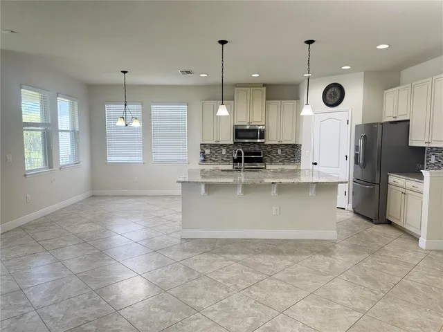 a large kitchen with cabinets and stainless steel appliances
