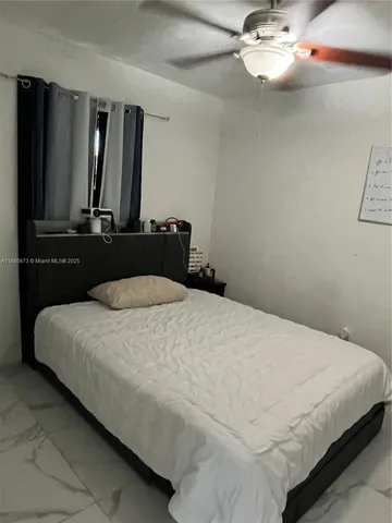 a bedroom with a large bed and mirror on dresser