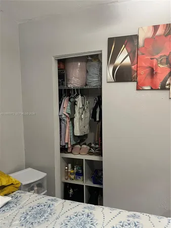 a bedroom with a bed and a ceiling fan