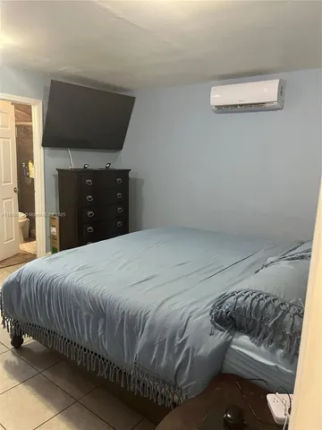 a bedroom with a bed and a night stand