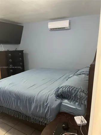 a bedroom with a bed and a mirror