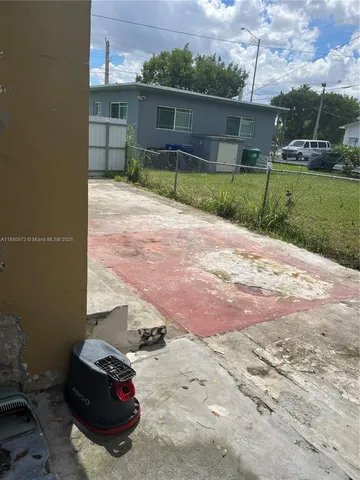 a view of backyard with barbeque grill and outdoor seating