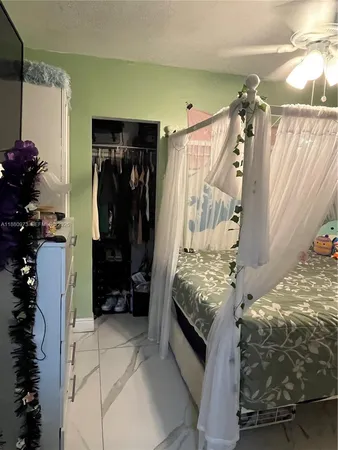 a view of kitchen with stainless steel appliances kitchen island granite countertop a refrigerator and a stove