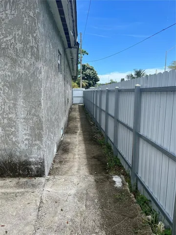 a view of a pathway with a wooden fence