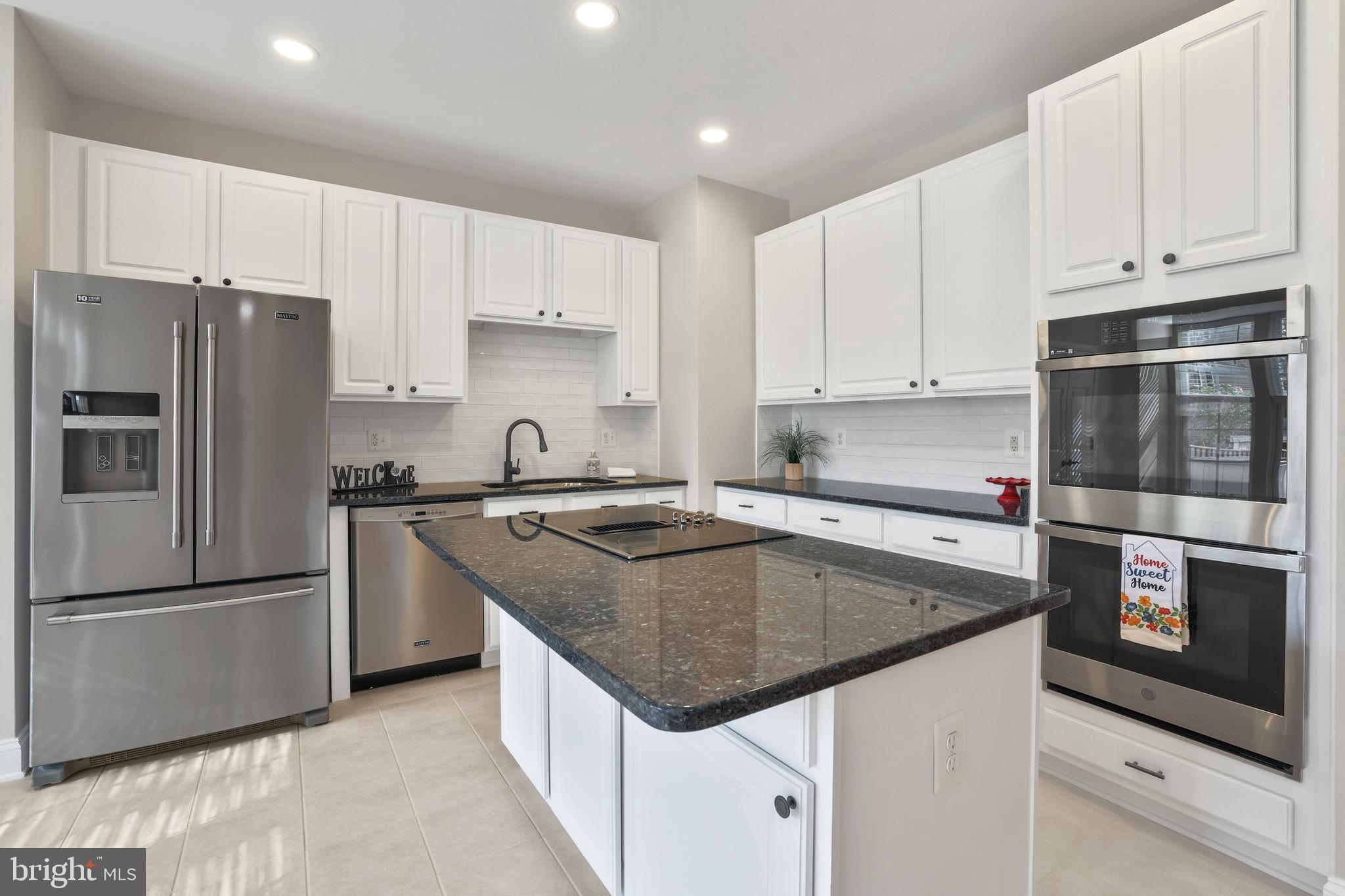 401 Yorkshire Ridge Court Purcellville, VA 20132 - Photo 22 of 64 a kitchen with granite countertop a center island stainless steel appliances and cabinets