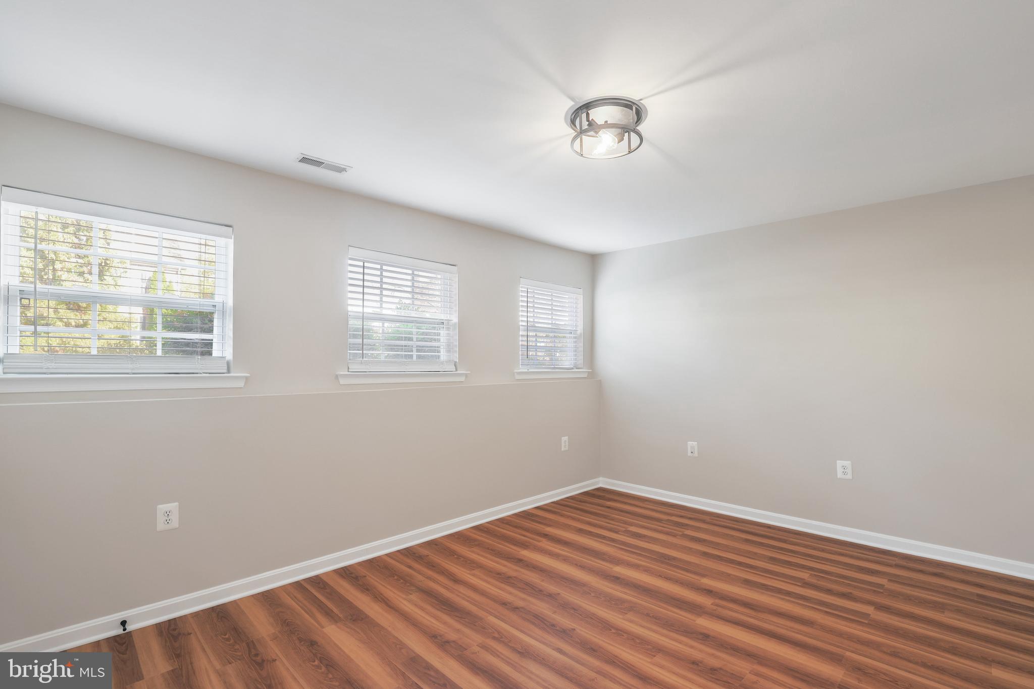 401 Yorkshire Ridge Court Purcellville, VA 20132 - Photo 53 of 64 a view of an empty room with wooden floor and a window