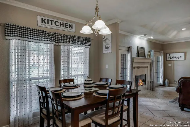 a dining room with a wooden table and chairs