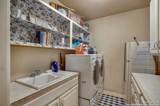 a bathroom with a sink and a washing machine