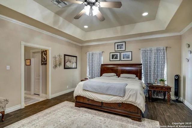 a spacious bedroom with a bed and a chandelier