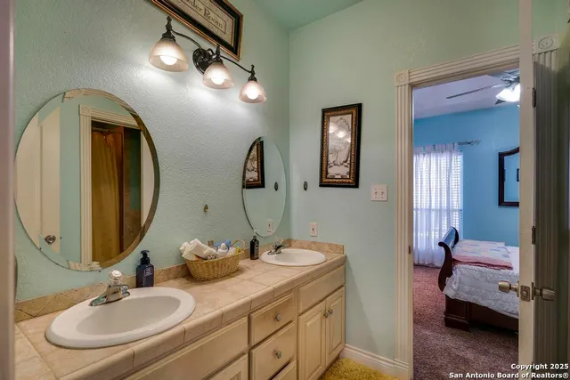 a bathroom with a double vanity sink and a mirror