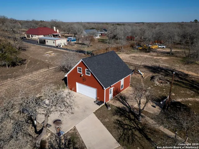 an aerial view of a houses with a yard