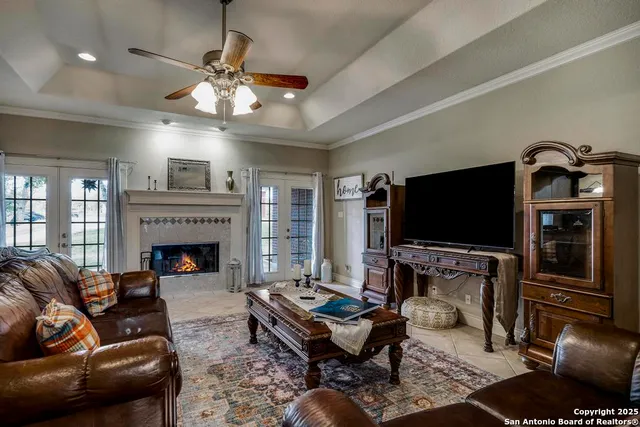 a living room with furniture a flat screen tv and a fireplace