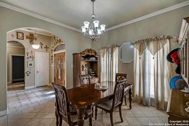 a view of a dining room with furniture and a chandelier