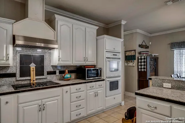 a kitchen with stainless steel appliances granite countertop a refrigerator sink and stove