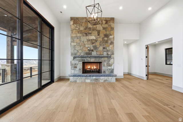 2155 East Wrangler Road Kamas, UT 84036 - Photo 40 of 62 Unfurnished living room featuring a stone fireplace, light wood-style flooring, a high ceiling, and recessed lighting