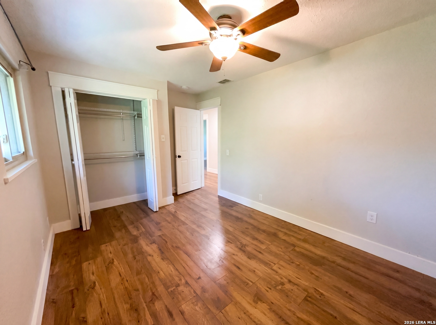 15422 Geronimo Loop San Antonio, TX 78254 - Photo 15 of 21 an empty room with wooden floor and a ceiling fan
