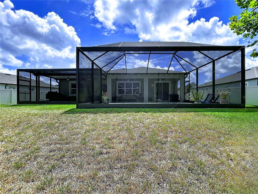 18078 Romanesque Court Spring Hill, FL 34610 - Photo 66 of 81 a view of a house with a yard and garage