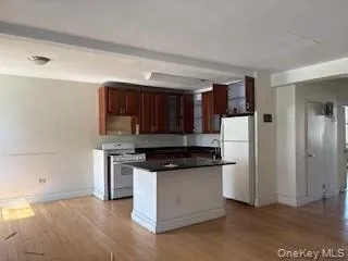 a kitchen with stainless steel appliances granite countertop a stove a refrigerator and a cabinets