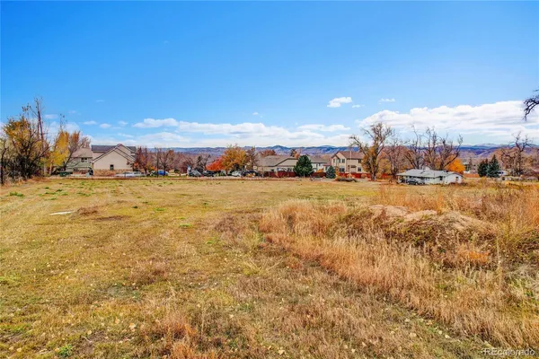 a view of a lake with houses in the back