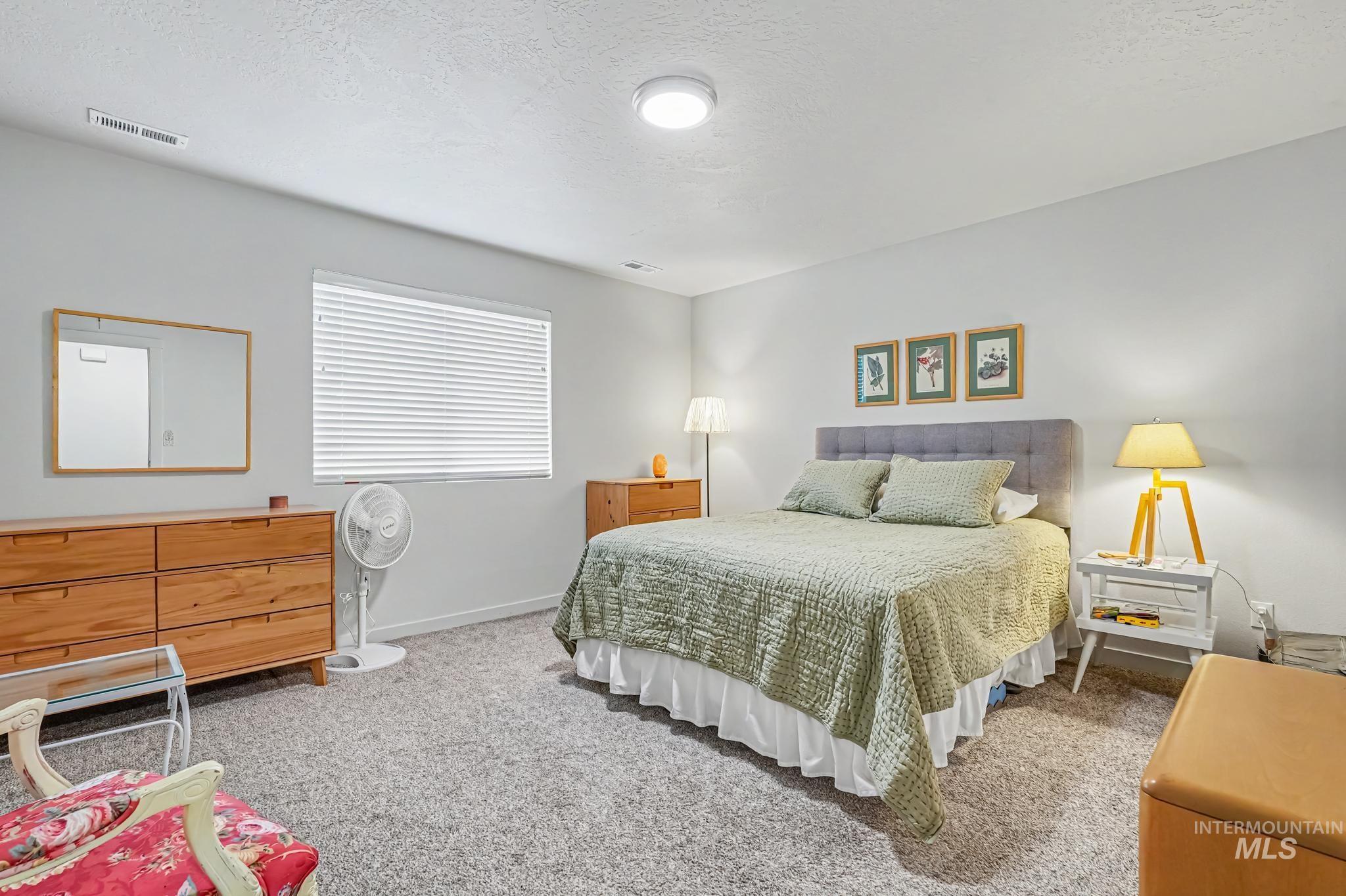 238 West Riggs Spring Avenue Meridian, ID 83642 - Photo 14 of 16 Plush carpeting, recessed lighting, and a window with blinds