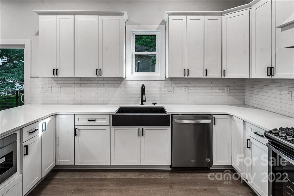 16025 Kiki Court Tega Cay, SC 29708 - Photo 12 of 39 a kitchen with white cabinets and white appliances