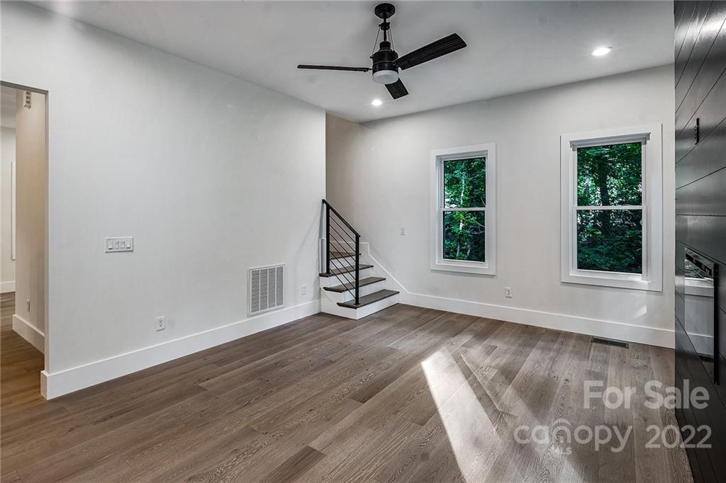 16025 Kiki Court Tega Cay, SC 29708 - Photo 17 of 39 a view of an empty room with wooden floor and a window