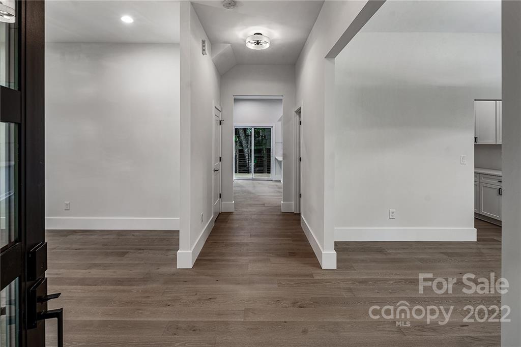 16025 Kiki Court Tega Cay, SC 29708 - Photo 2 of 39 a view of a hallway with wooden floor