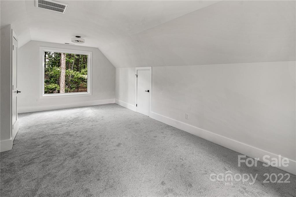 16025 Kiki Court Tega Cay, SC 29708 - Photo 24 of 39 a view of a big room with windows and chandelier fan