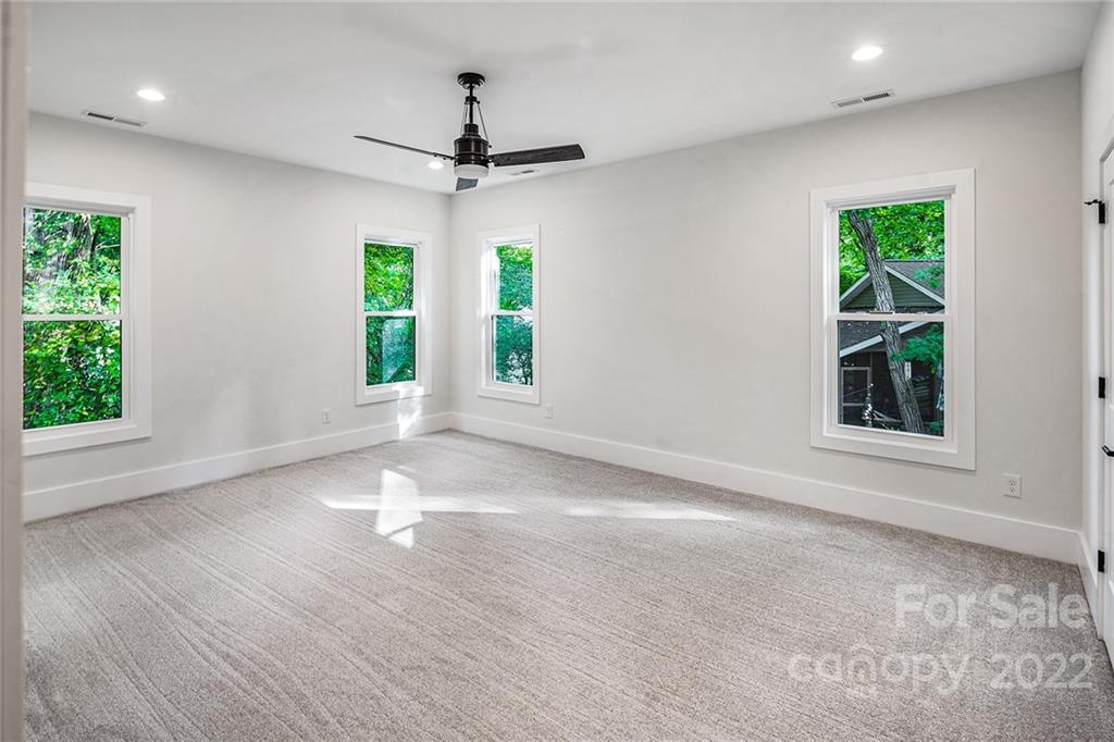 16025 Kiki Court Tega Cay, SC 29708 - Photo 27 of 39 a view of an empty room with a window and wooden floor