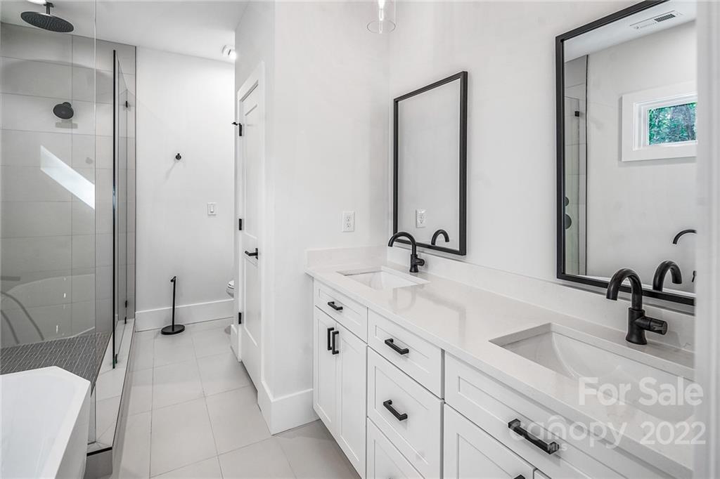16025 Kiki Court Tega Cay, SC 29708 - Photo 31 of 39 a bathroom with a double vanity sink and a mirror