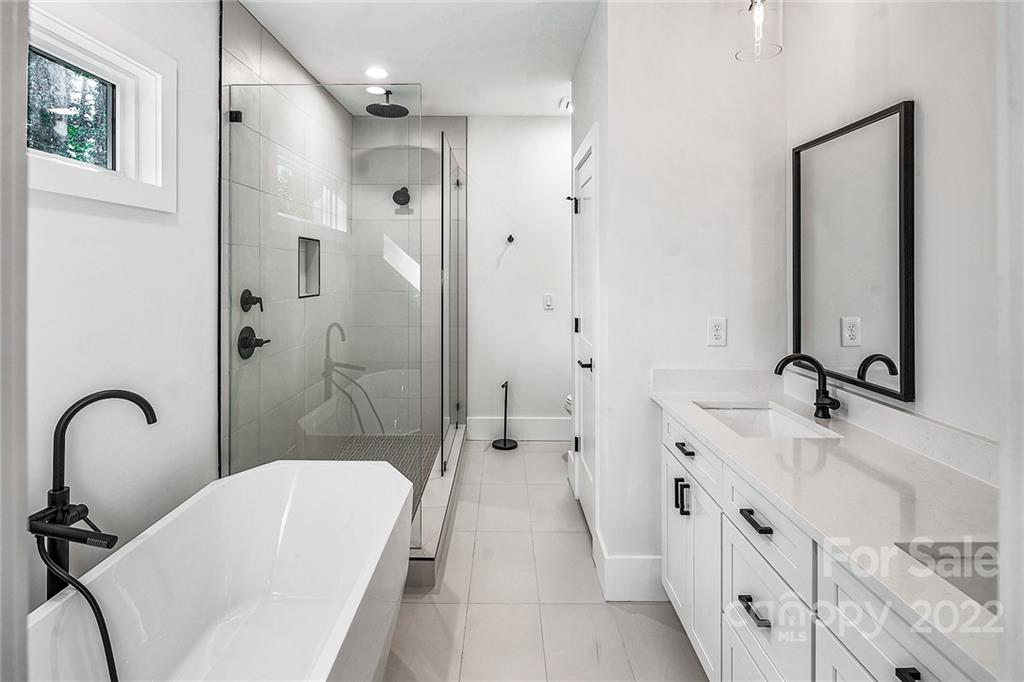 16025 Kiki Court Tega Cay, SC 29708 - Photo 32 of 39 a bathroom with a double vanity sink a toilet and a mirror