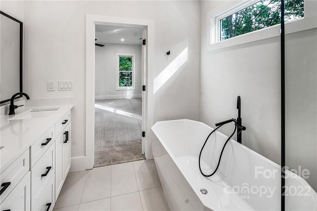 16025 Kiki Court Tega Cay, SC 29708 - Photo 33 of 39 a bathroom with a bathtub and a shower