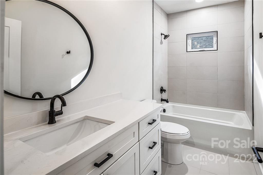 16025 Kiki Court Tega Cay, SC 29708 - Photo 35 of 39 a bathroom with a sink a toilet and a mirror