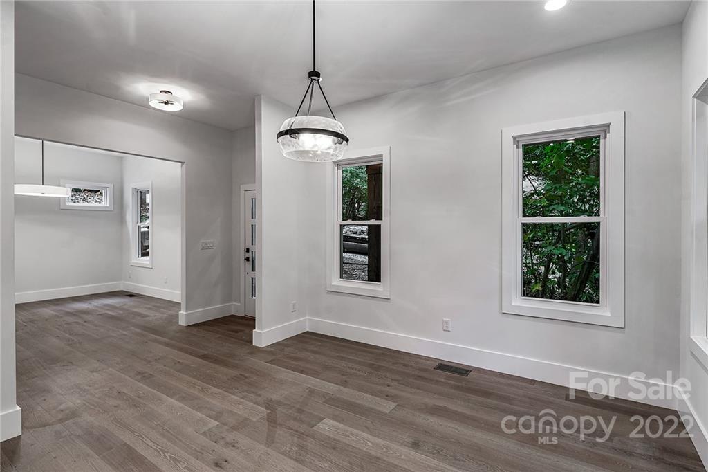 16025 Kiki Court Tega Cay, SC 29708 - Photo 4 of 39 a view of a room with wooden floor chandelier and windows
