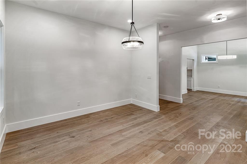 16025 Kiki Court Tega Cay, SC 29708 - Photo 5 of 39 a view of a room with wooden floor and ceiling fan