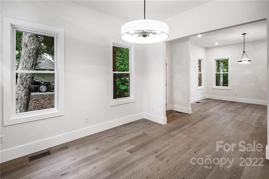 16025 Kiki Court Tega Cay, SC 29708 - Photo 7 of 39 an empty room with wooden floor and windows