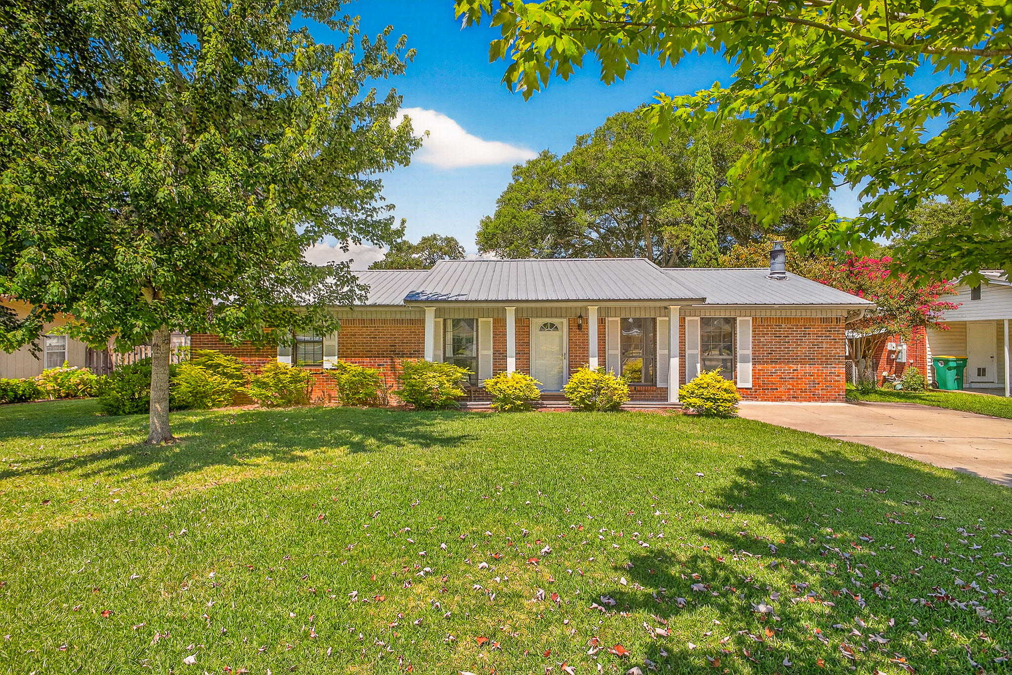 a front view of a house with a yard porch and outdoor seating