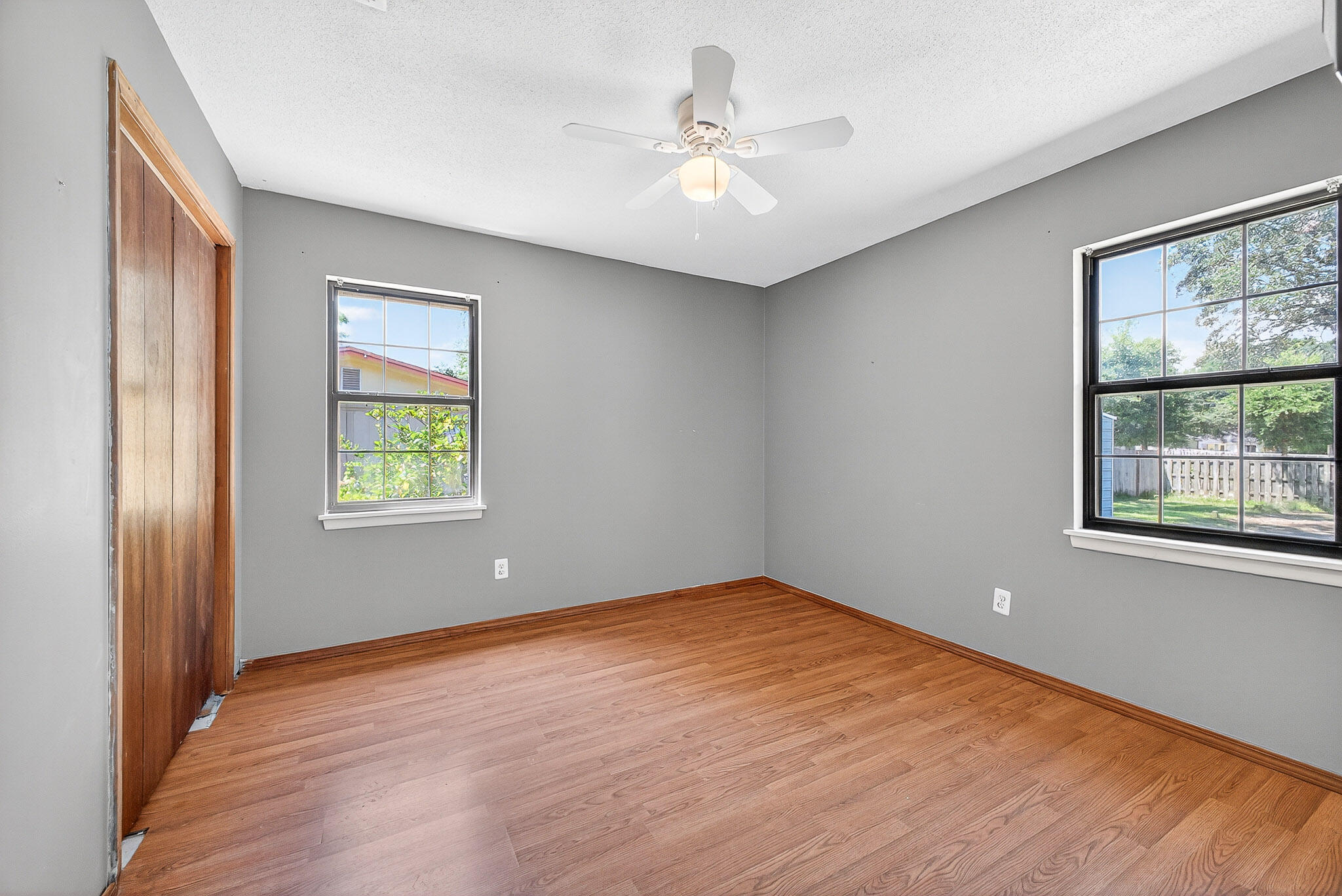 121 Boyce Road Shalimar, FL 32579 - Photo 20 of 34 a view of an empty room with a window and wooden floor