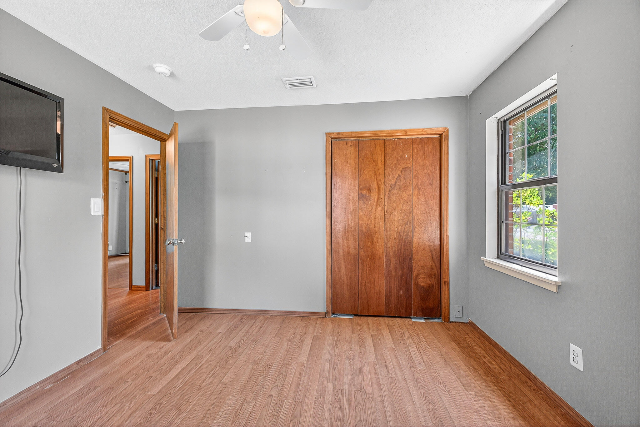 121 Boyce Road Shalimar, FL 32579 - Photo 22 of 34 an empty room with wooden floor and windows
