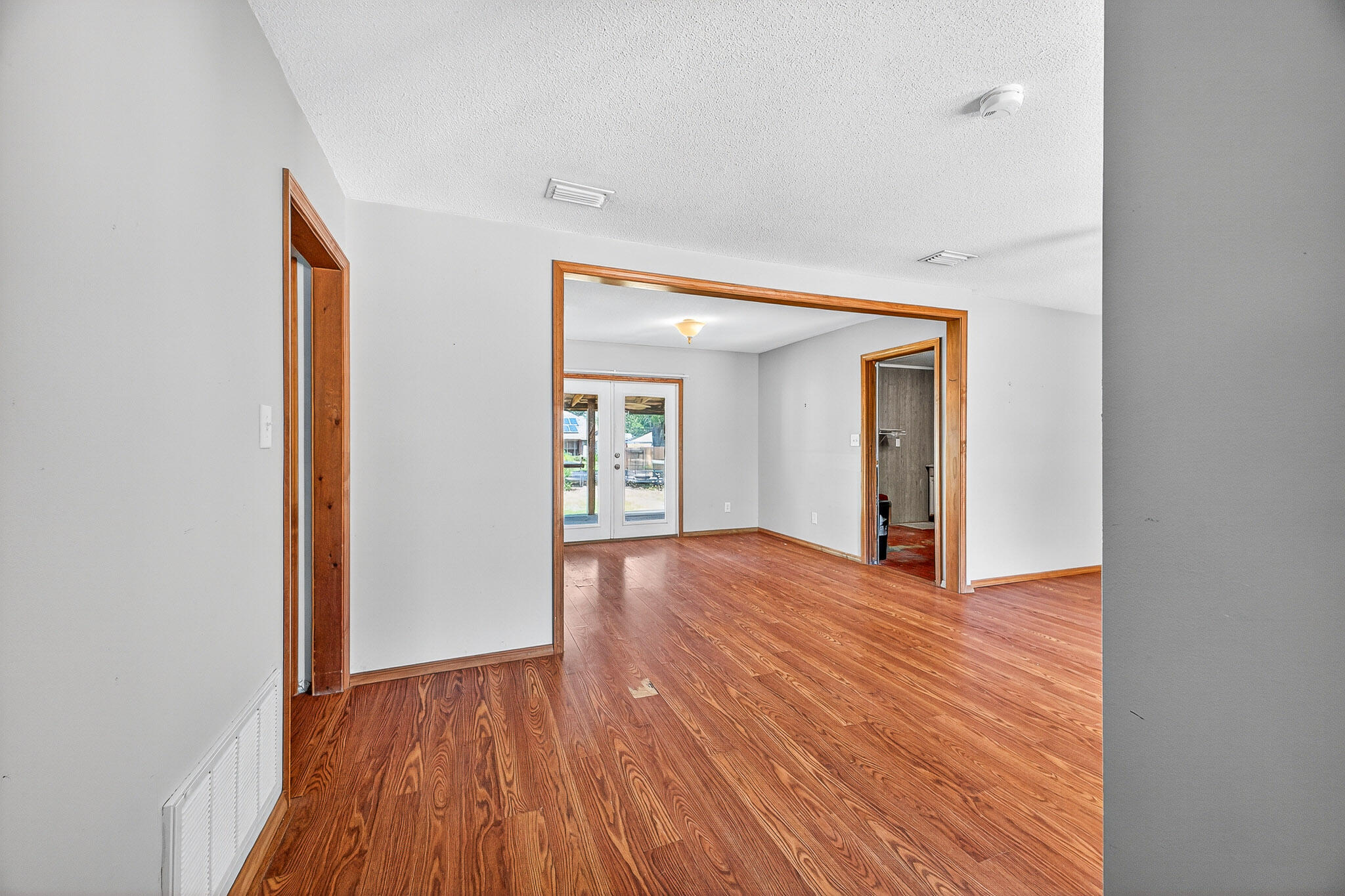 121 Boyce Road Shalimar, FL 32579 - Photo 3 of 34 a view of an empty room with wooden floor and a window