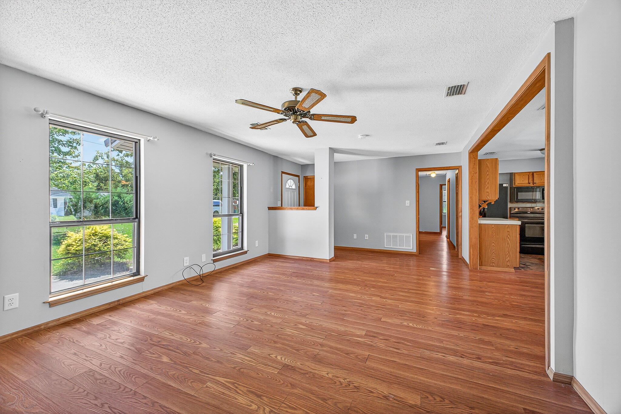 121 Boyce Road Shalimar, FL 32579 - Photo 5 of 34 a view of an empty room with window and wooden floor
