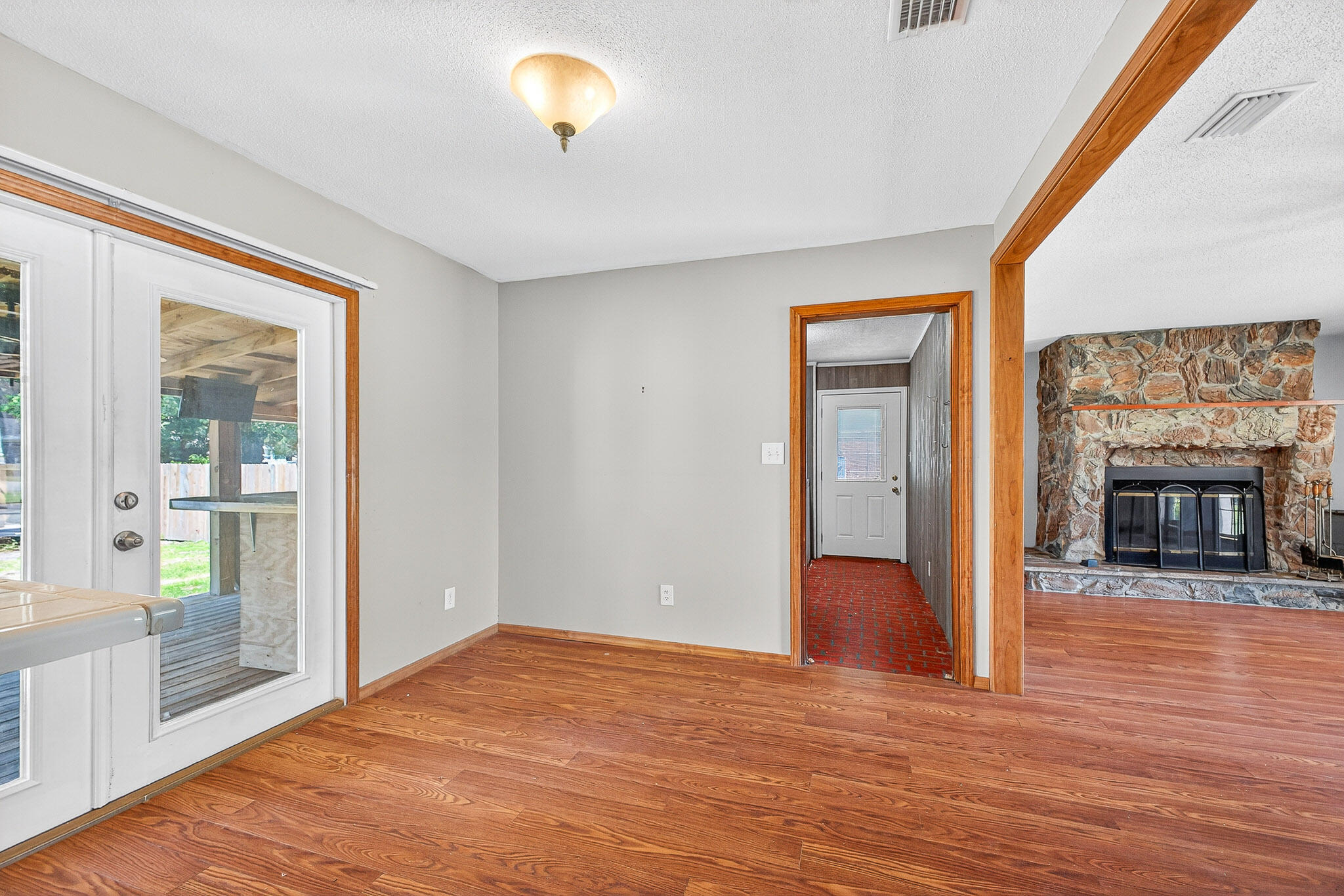 121 Boyce Road Shalimar, FL 32579 - Photo 8 of 34 a view of an empty room with wooden floor and a fireplace