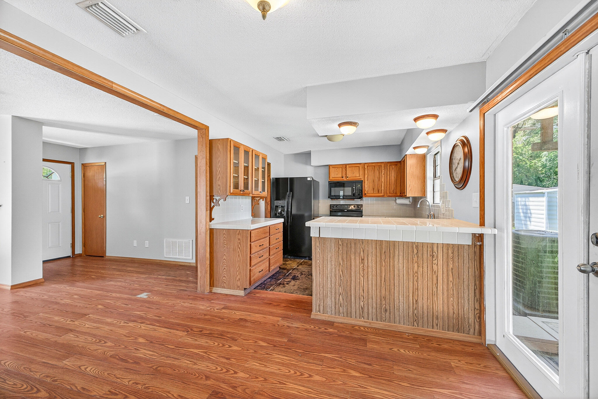 121 Boyce Road Shalimar, FL 32579 - Photo 9 of 34 a view of a kitchen with kitchen island wooden floor and window